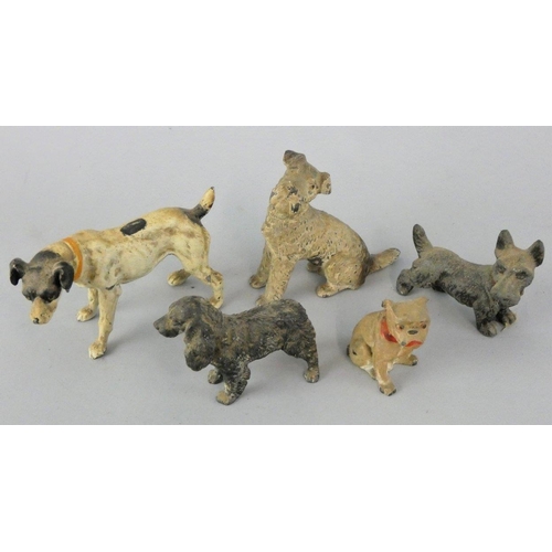 141 - An early 20th century collection of five cold painted lead dogs, to include a Scottie and a Spaniel ... 