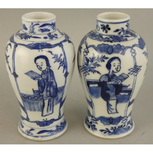 202 - A Chinese pair of blue and white baluster vases, Kangsi four character marks, decorated with a lady ... 