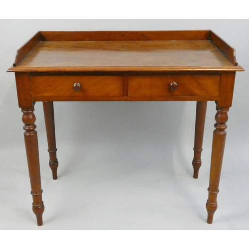 282 - Crane Bros, an Edwardian mahogany writing table, the 3/4 gallery top with two frieze drawers, turned... 