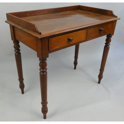 282 - Crane Bros, an Edwardian mahogany writing table, the 3/4 gallery top with two frieze drawers, turned... 