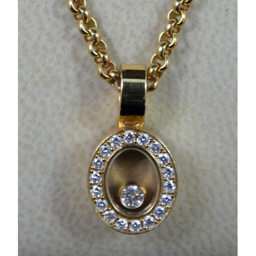 80 - A Chopard Happy Diamond pendant, the oval design, featuring loose diamond to centre, surrounded by a... 