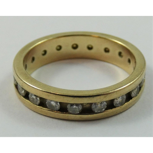 83 - A 9ct gold diamond set eternity ring, channel set with brilliant cut stone, size K 1/2.