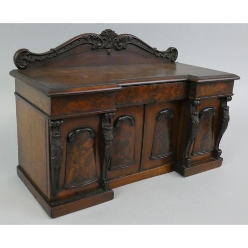 132 - A George IV flame mahogany tea caddy modelled as a sideboard, circa 1825, of inverted breakfront for... 