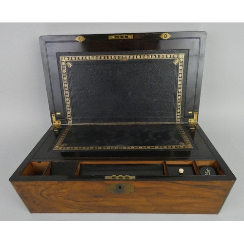 142 - A Victorian rosewood and brass inlaid writing slope, opening to reveal an ebonised interior with a l... 