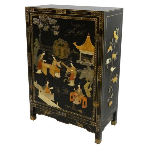 256 - A Chinese black cabinet, the front decorated with applied resin figures in a garden, the sides with ... 