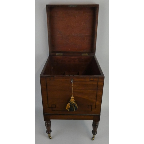 280 - An Edwardian mahogany square cellarette, the boxwood strung lid opening to reveal nine bottle compar... 