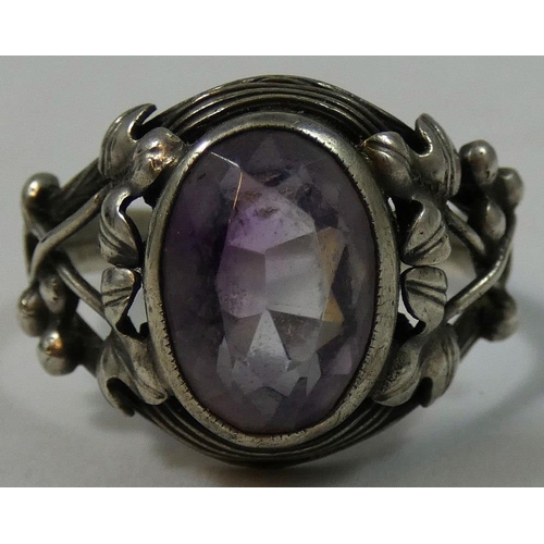 87 - A silver Arts & Craft and amethyst ring, probably Birmingham School of Arts, the collet set stone in... 