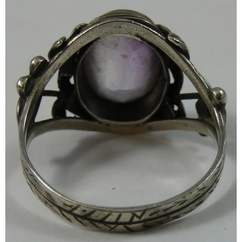 87 - A silver Arts & Craft and amethyst ring, probably Birmingham School of Arts, the collet set stone in... 