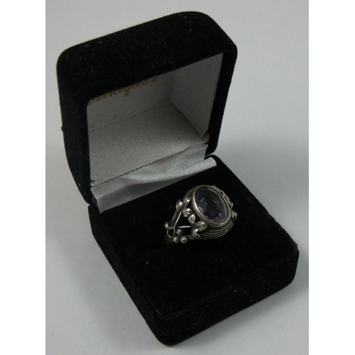 87 - A silver Arts & Craft and amethyst ring, probably Birmingham School of Arts, the collet set stone in... 