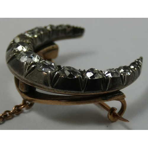 94 - A Victorian silver set diamond crescent brooch, rub over set with graduated old cut stones, total we... 