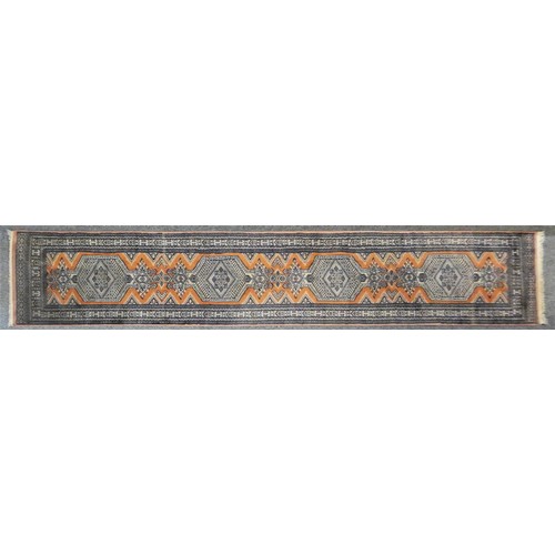 166 - A 20th century Tekke Turkman runner, with madder field and geometric guls, 315 x 75 cm.