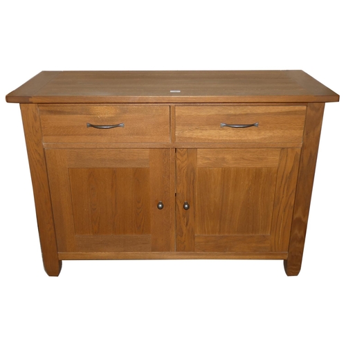 197 - A Marks and Spencer oak sideboard composed of two drawers over two cupboard doors, 123cm long x 85cm... 