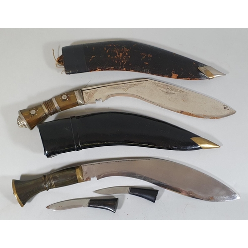 71 - An Indian Kukri, with horn hilt and prick dot decoration, together with another Kukri with hardwood ... 