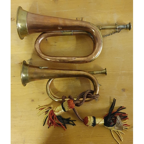 63 - A War Department copper and brass Premier bugle, dated 1936 and 9, 36 cm and a smaller bugle (2).