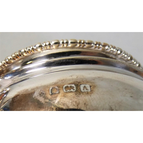 10 - A silver cream jug, Birmingham 1925, of baluster form with gadrooned border, 3 oz.