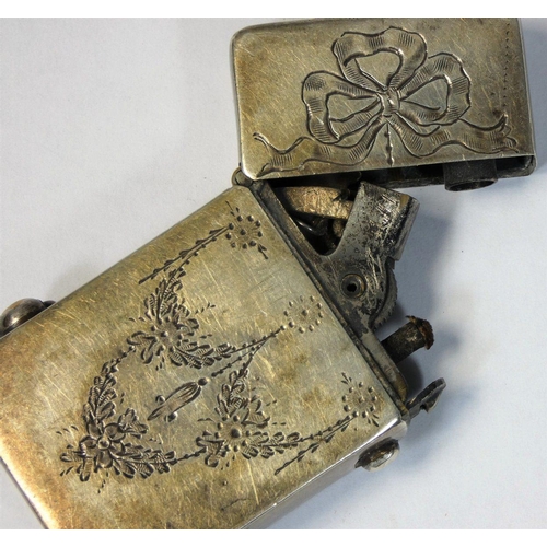 16 - An Edwardian Sterling Silver petrol lighter, stamped sterling silver case, with ribbon and garland e... 