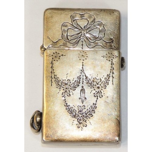 16 - An Edwardian Sterling Silver petrol lighter, stamped sterling silver case, with ribbon and garland e... 