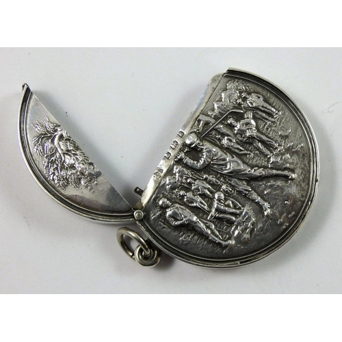 17 - An Edwardian silver golfing vesta case, Birmingham 1906, of circular form, the central figure in ful... 