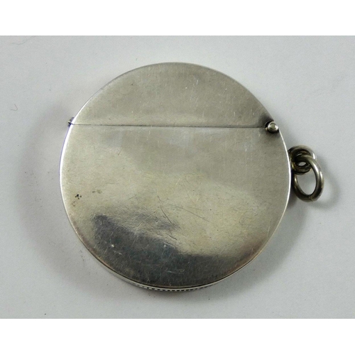 17 - An Edwardian silver golfing vesta case, Birmingham 1906, of circular form, the central figure in ful... 