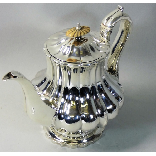 19 - A William IV silver coffee pot, by George Burrows II, London 1826, of lobed baluster form, raised on... 