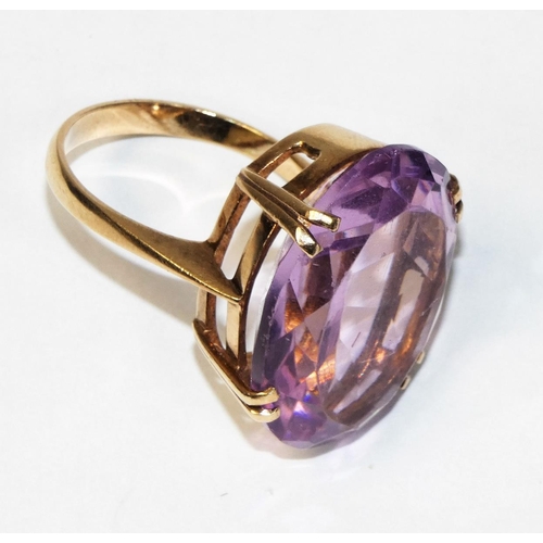 20 - A 9ct rose gold mounted amethyst ring, four claw set with on oval mixed cut stone, 25 x 20 mm, size ... 