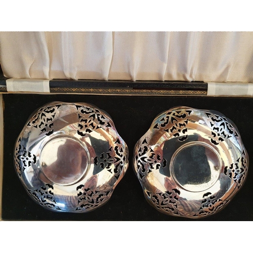 4 - A silver pair of pierced bon bon dishes, Birmingham 1943, diameter 12cm, 3.5 oz, case.
