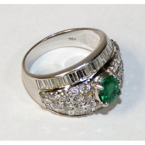49 - An 18ct white gold emerald and diamond dress ring, claw set with an oval mixed cut stone, weighing a... 