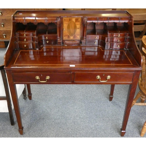 158 - A mahogany writing desk fitted with twelve draws, inlaid centre section on tapering legs, 102 cm lon... 