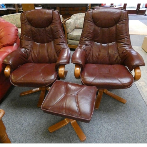 172 - A pair of red swivel armchairs with matching footstool