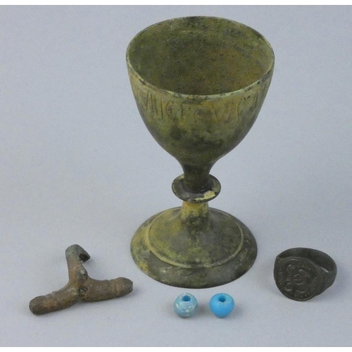 119 - Two Roman glass beads, a bronze goblet, a Roman finger ring, a Roman bow brooch, together with Porta... 