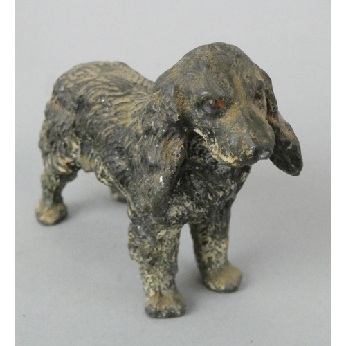 141 - An early 20th century collection of five cold painted lead dogs, to include a Scottie and a Spaniel ... 