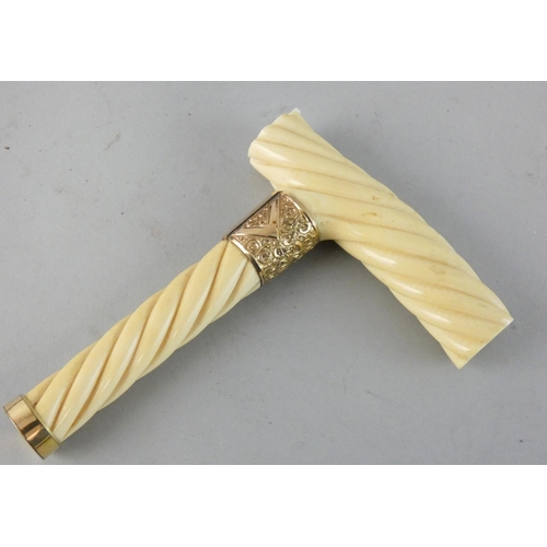 150 - A Victorian ivory cane handle with carved twist decoration, applied gilt metal mounts, length 14.5 c... 