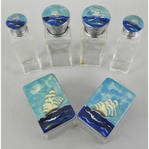 154 - An enamel and glass toilet bottle set, the lids with enamel Tea Clipper on the high sea decoration, ... 