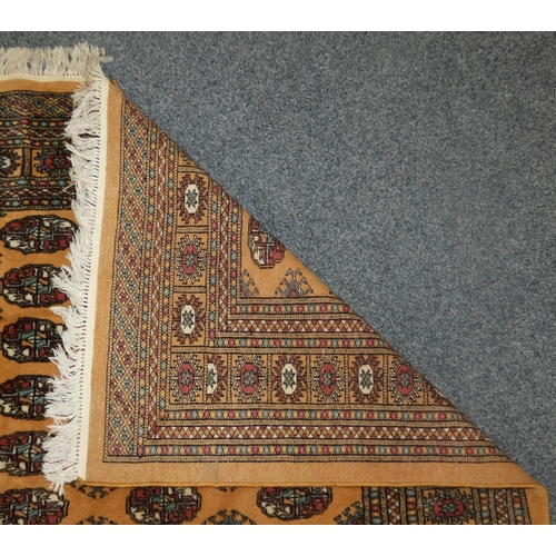 165 - A 20th century Tekke Turkmen rug, the sand field with geometric guls and border 265 x 190 cm.