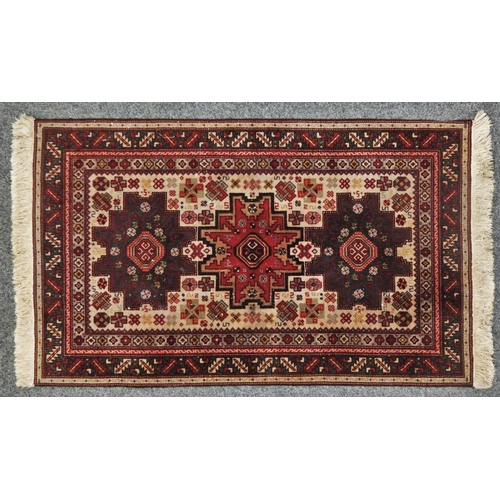 167 - A Persian rug, with three large gull motifs, 156 x 98 cm.