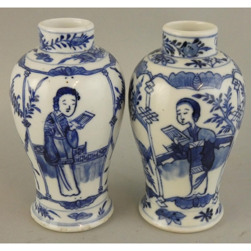 202 - A Chinese pair of blue and white baluster vases, Kangsi four character marks, decorated with a lady ... 