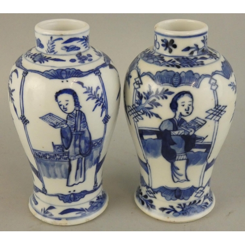 202 - A Chinese pair of blue and white baluster vases, Kangsi four character marks, decorated with a lady ... 