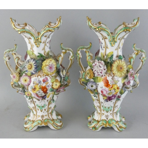 227 - A pair of late 19th century baluster vases, with applied and painted floral decoration, height 27 cm... 