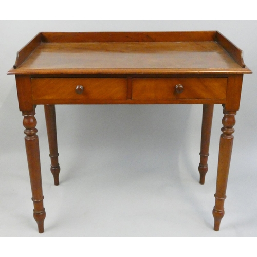 282 - Crane Bros, an Edwardian mahogany writing table, the 3/4 gallery top with two frieze drawers, turned... 