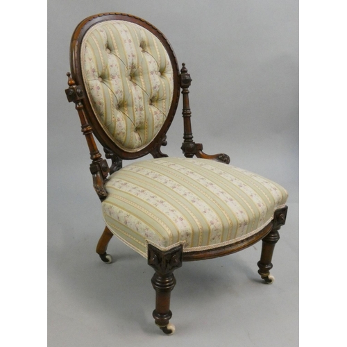 284 - A Victorian mahogany nursing chair, with button spoon back, raised on turned supports, porcelain and... 