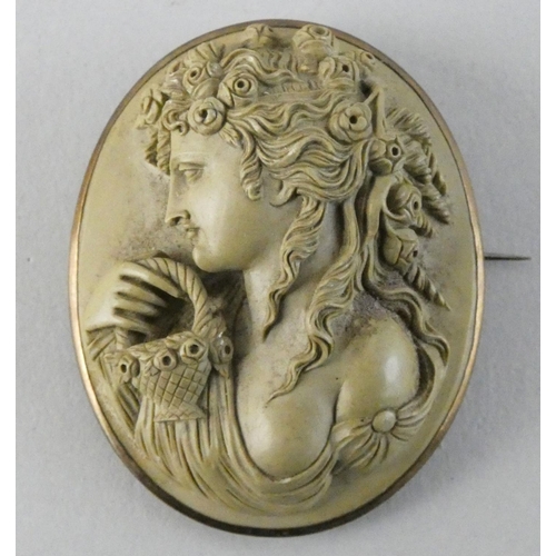 65 - A Victorian lava cameo brooch, depicting Flora with a basket, 4.5 x 4 cm.