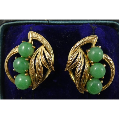 73 - A pair of 14 ct gold and jade earclips, by J.A.W., of scroll form set with cabochon stones, case.