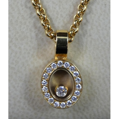 80 - A Chopard Happy Diamond pendant, the oval design, featuring loose diamond to centre, surrounded by a... 