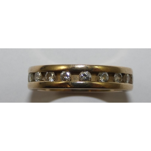 83 - A 9ct gold diamond set eternity ring, channel set with brilliant cut stone, size K 1/2.