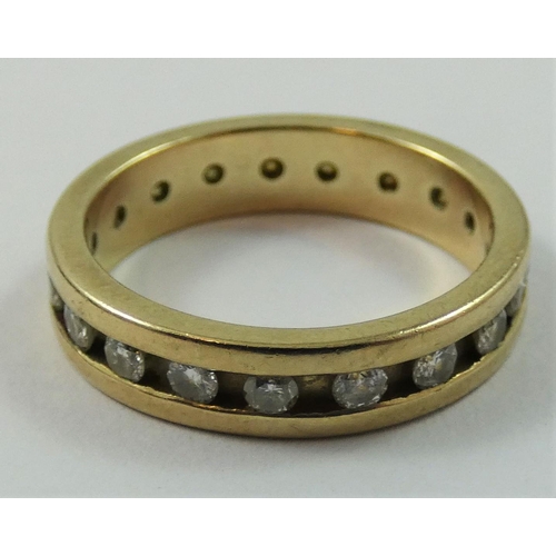 83 - A 9ct gold diamond set eternity ring, channel set with brilliant cut stone, size K 1/2.