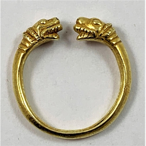 84 - A gold Viking style torque ring, unmarked, with mythological animal head terminals, size R, weight 6... 