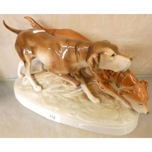 174 - A mid-20th century Royal Dux porcelain figure group of two hunting dogs, height 19cm.