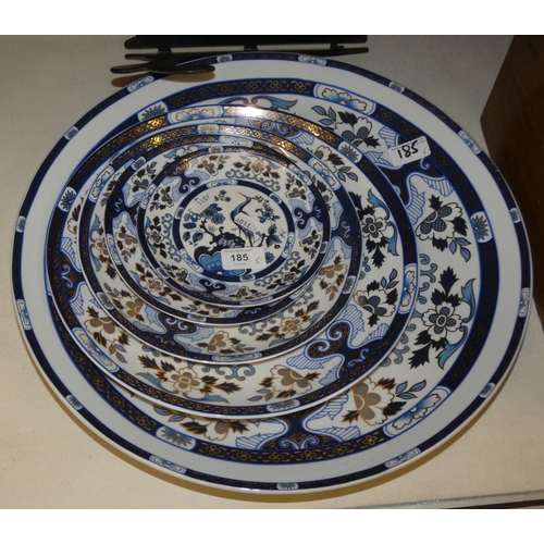 185 - A set of five graduated Chinese blue and white plates and platters, decorated with peacocks and flow... 