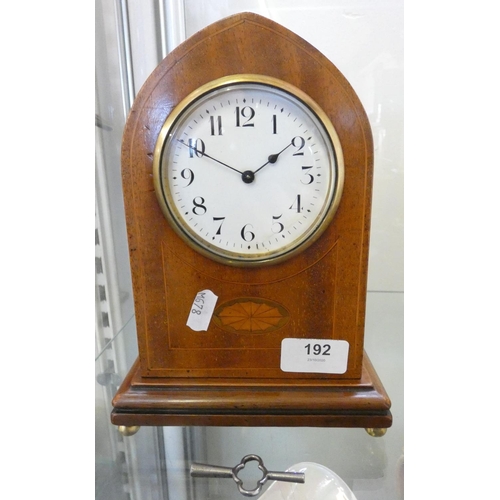 192 - An Edwardian inlaid oak arched top mantel timepiece, circular silvered Arabic dial, barrel movement ... 