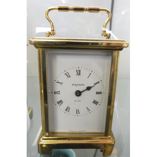 194 - A brass cased carriage clock with eight-day movement, the enamel dial with Roman numerals and inscri... 